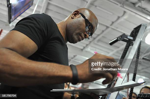 Mixed martial artist Anderson Silva of Brazil autographs UFC memorabilia for fans during a Q&A session at UFC Gym on September 23, 2013 in Torrance,...