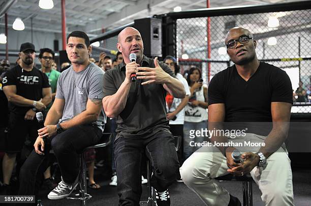 President Dana White talks along side mixed martial artist Chris Weidman of the United States and mixed martial artist Anderson Silva of Brazil...