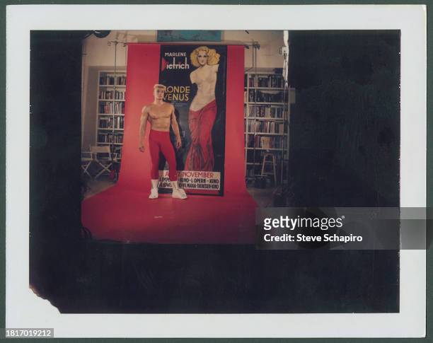 Portrait of Swedish actor Dolph Lundgren as he poses beside a poster for the film 'Blond Venus' , Los Angeles, California, 1985.