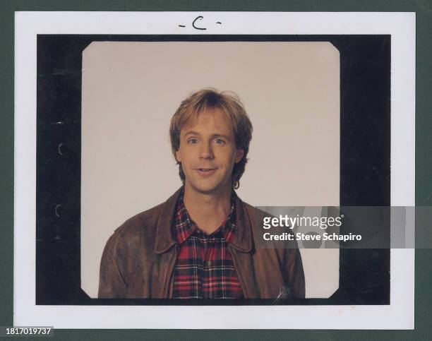 Portrait of American comedian and actor Dana Carvey as he poses against a white background, Los Angeles, California, 1990.