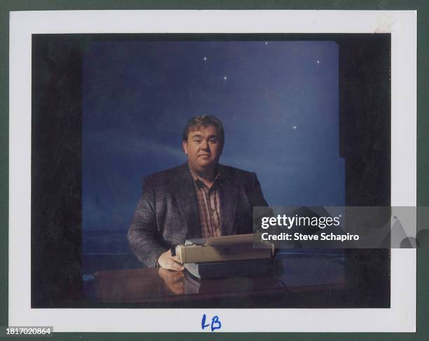 Portrait of Canadian actor and comedian John Candy as he sits behind a typewriter, for the film 'Delirious' , Los Angeles, California, 1991.