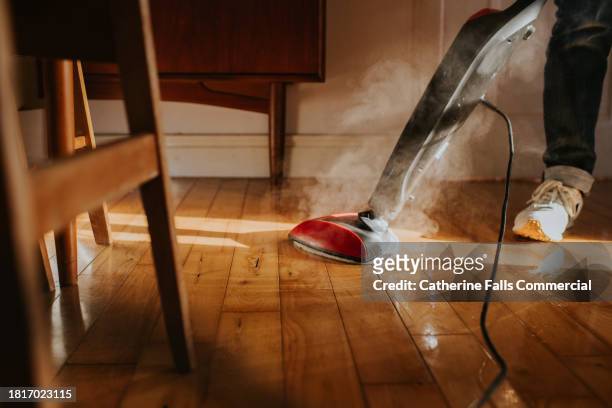 a person mops the floor using an electric steam mop - maid hoovering stock pictures, royalty-free photos & images