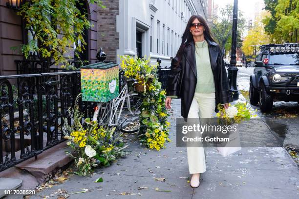 Katie Holmes is seen in NYC receiving a delivery of flowers and champagne from Perrier-Jouët on a chic, nature-inspired bicycle adorned with local...