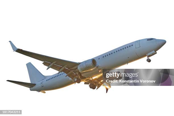airplane in flight isolated on white background with sunlight - plane fuselage stock pictures, royalty-free photos & images