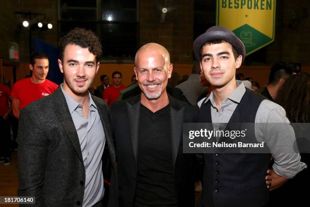 Designer Italo Zucchelli of Calvin Klein poses with Joe Jonas and Kevin Jonas at the GQ & Gap event to celebrate 2013 Best New Menswear Designers...