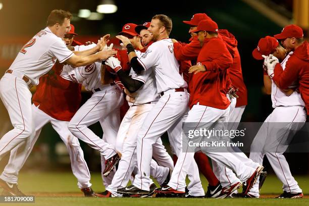 Shin-Soo Choo of the Cincinnati Reds is congratulated by his teammates after hitting a walk-off double to defeat the New York Mets 3-2 in the 10th...