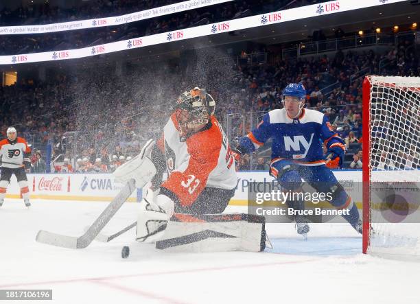 Samuel Ersson of the Philadelphia Flyers makes the save as Casey Cizikas of the New York Islanders looks for the rebound at UBS Arena on November 25,...