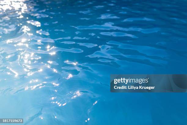 water surface in a swimming pool. - swimming pool texture stock pictures, royalty-free photos & images