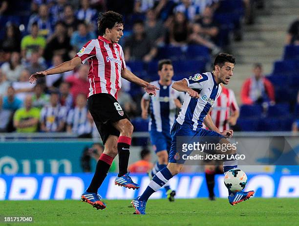 Athletic Bilbao's midfielder Ander Iturraspe vies with Espanyol's Argentinian forward Luis Pizzi during the Spanish league football match Espanyol vs...