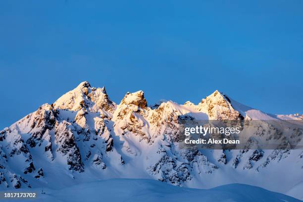 sun lit mountain top at sunset - rhône alpes photos et images de collection