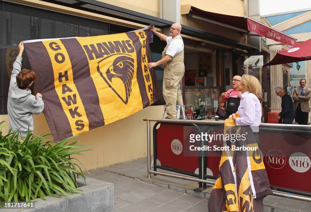 Large Hawthorn Hawks flag is hung from a window outside of a shop on Glenferrie Road in Hawthorn on September 24, 2013 in Melbourne, Australia. The...