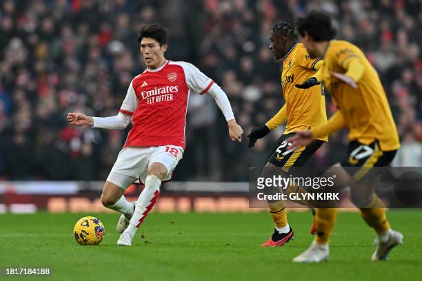 Arsenal's Japanese defender Takehiro Tomiyasu controls the ball during the English Premier League football match between Arsenal and Wolverhampton...