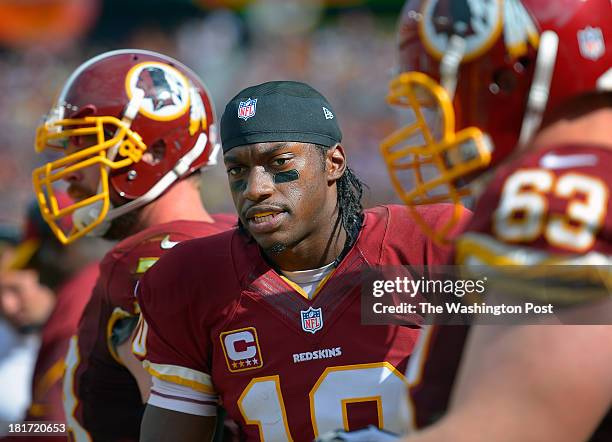 Washington quarterback Robert Griffin III , center, prepares to go out onto the field with the offense during the Detroit Lions defeat of the...