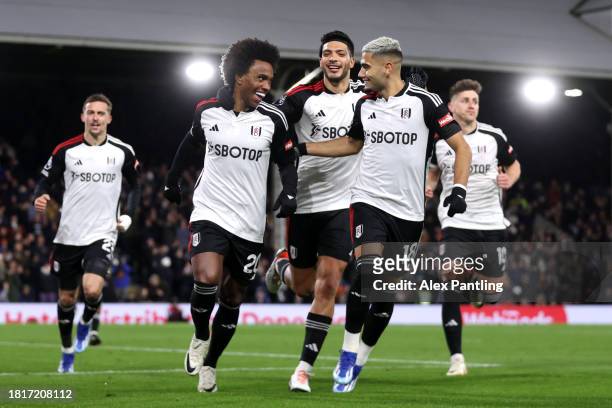 Willian of Fulham celebrates after scoring the team's second goal from a penalty kick with teammates during the Premier League match between Fulham...