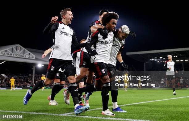 Willian of Fulham celebrates after scoring the team's second goal from a penalty kick with teammates during the Premier League match between Fulham...