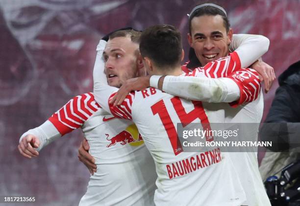 Leipzig's Danish forward Yussuf Poulsen celebrates with teammates scoring during the German first division Bundesliga football match between RB...