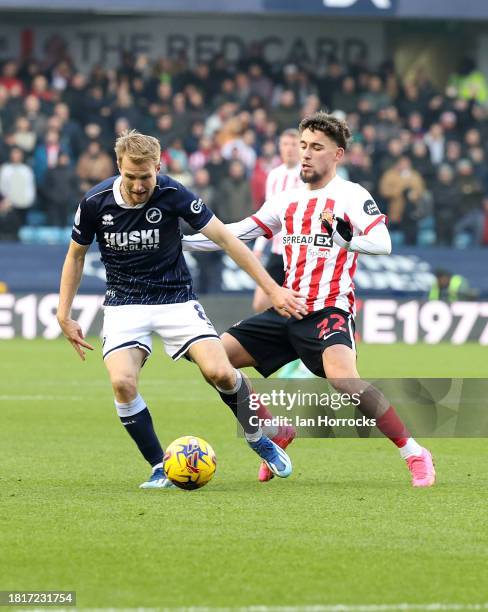 Billy Mitchell of Millwall tries to hold off Adil Aouchiche of Sunderland during the Sky Bet Championship match between Millwall and Sunderland at...