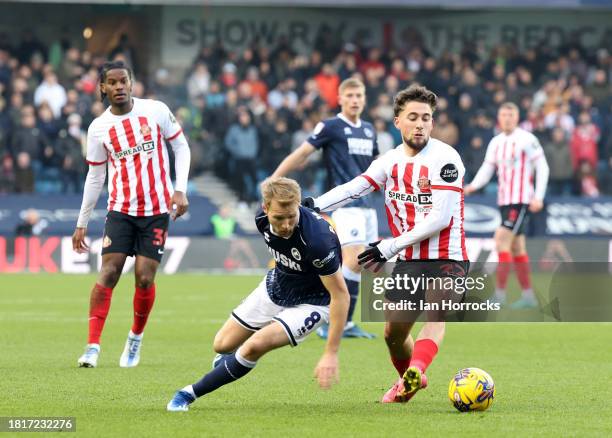 Billy Mitchell of Millwall tries to hold off Adil Aouchiche of Sunderland during the Sky Bet Championship match between Millwall and Sunderland at...