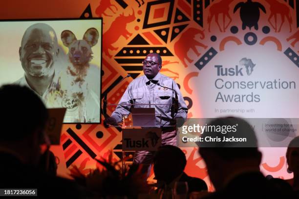 Jealous Mpofu receives the Wildlife Ranger Award with Peter Blinston of Painted Dog Conservation in Zimbabwe onstage during the 2023 Tusk...