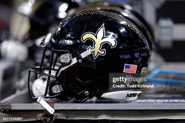 New Orleans Saints helmet sits atop an equipment case in the bench area during halftime against the Atlanta Falcons at Mercedes-Benz Stadium on...