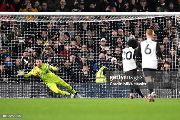 Willian of Fulham scores the team's third goal from a penalty kick as Jose Sa of Wolverhampton Wanderers fails to make a save during the Premier...