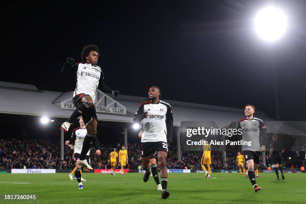 Willian of Fulham celebrates after scoring the team's third goal from a penalty kick with teammates during the Premier League match between Fulham FC...