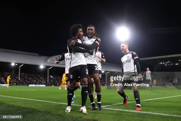 Willian of Fulham celebrates after scoring the team's third goal from a penalty kick with teammates during the Premier League match between Fulham FC...