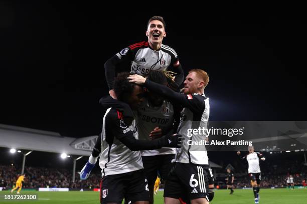 Willian of Fulham celebrates after scoring the team's third goal from a penalty kick with teammates during the Premier League match between Fulham FC...