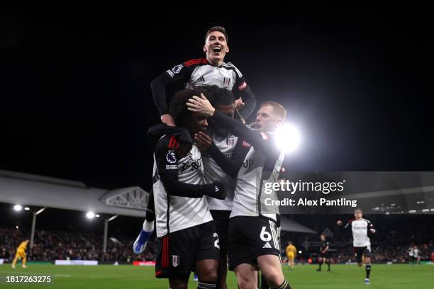 Willian of Fulham celebrates after scoring the team's third goal from a penalty kick with teammates during the Premier League match between Fulham FC...