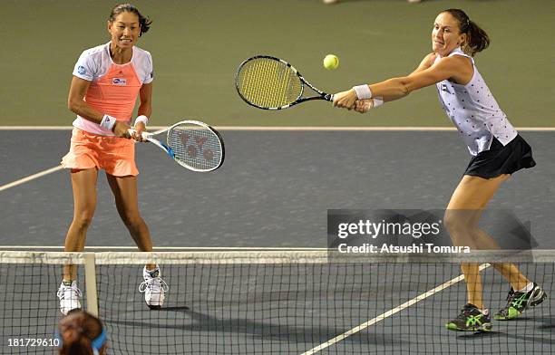 Kimiko Date-Krumm of Japan and Arantxa Parra Santonja of Spain in action during their match against Hao-Ching Chan of Chinese Taipei and Liezel Huber...