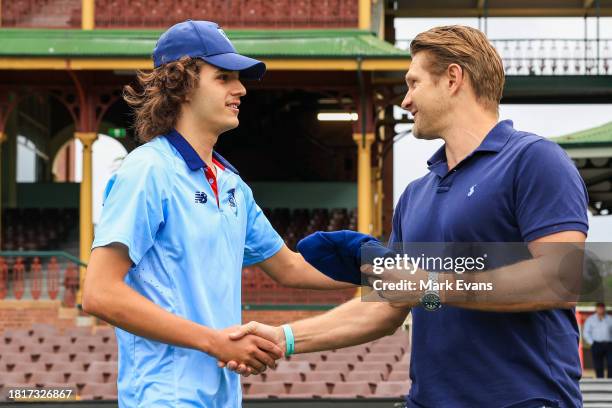 Sam Konstas of the Blues receives his debut cap by Shane Watson ahead of his debut during the Sheffield Shield match between New South Wales and...