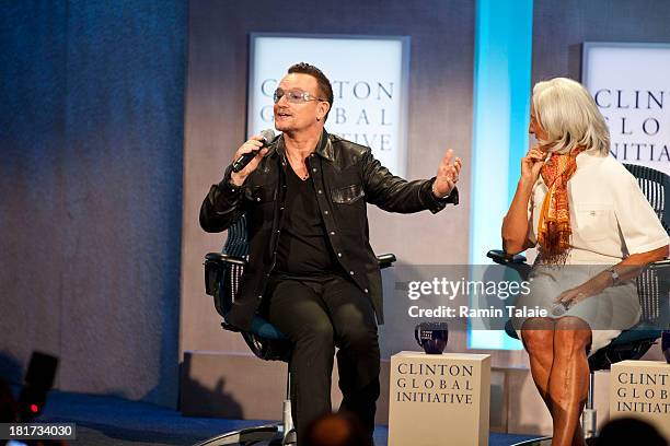 Bono, lead singer of U2, imitates Bill Clinton as Christine Lagarde, managing director of International Monetary Fund smiles during a panel at the...