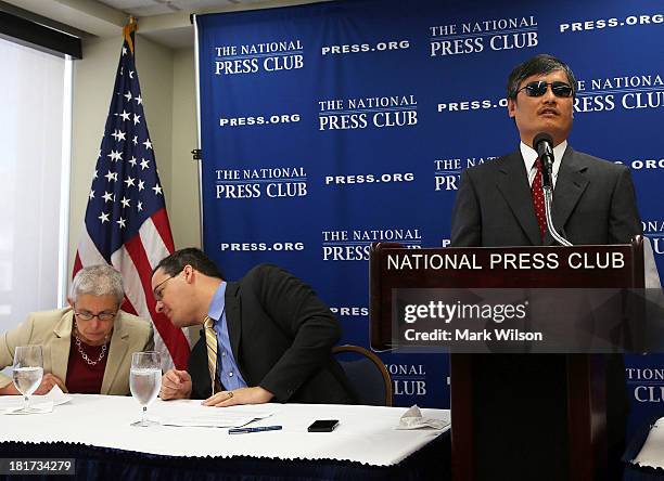 Chinese dissident Chen Guangcheng speaks while Jared Genser of Freedom Now and Sophie Richardson, , China director of Human Rights Watch sit nearby...