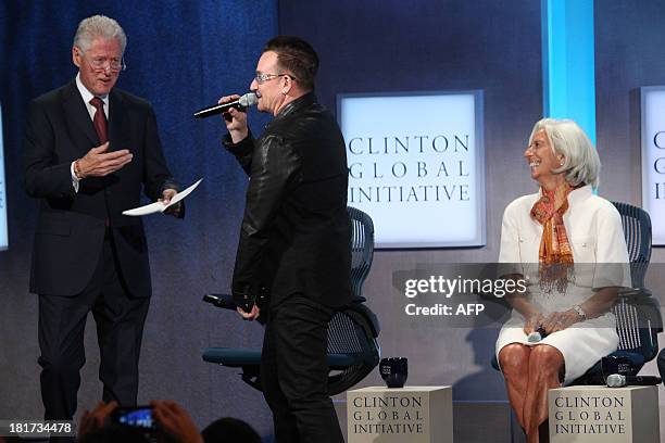Former US President Bill Clinton, Bono, lead singer U2 and Christine Lagarde, Managing Director, International Monetary Fund attend the Clinton...