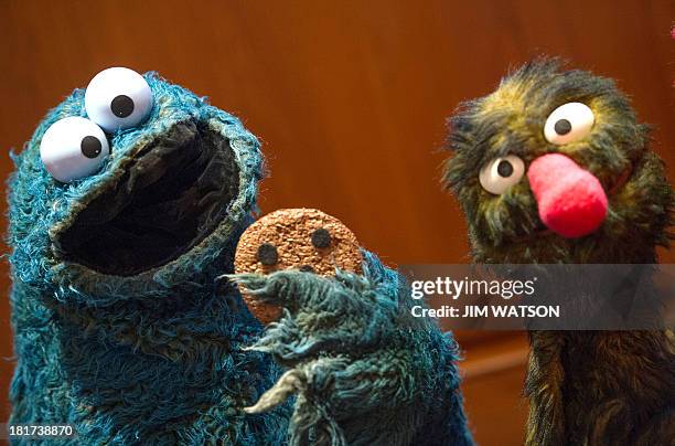 President of the Jim Henson Foundation Cheryl Henson Muppets Cookie Monster and Grover during a presentation a new of 20 Jim Henson puppets and props...