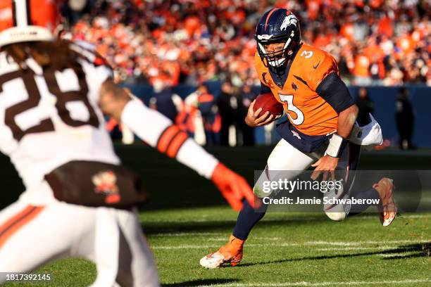 Russell Wilson of the Denver Broncos rushes for a touchdown against the Cleveland Browns at Empower Field At Mile High on November 26, 2023 in...