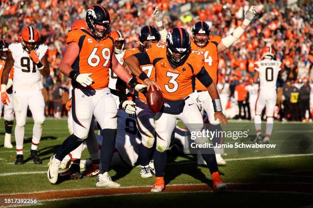 Russell Wilson of the Denver Broncos rushes for a touchdown against the Cleveland Browns at Empower Field At Mile High on November 26, 2023 in...