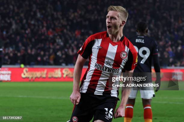 Brentford's English defender Ben Mee celebrates after scoring their second goal during the English Premier League football match between Brentford...