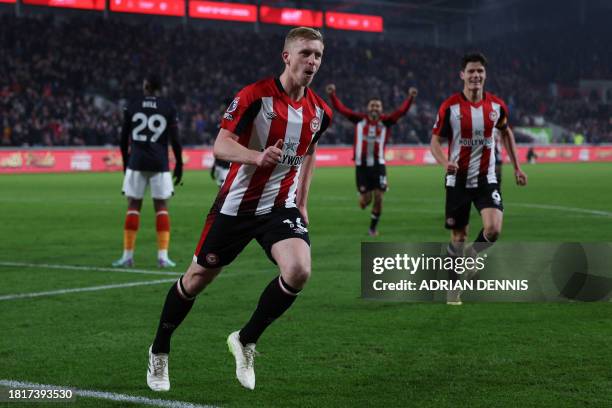 Brentford's English defender Ben Mee celebrates after scoring their second goal during the English Premier League football match between Brentford...