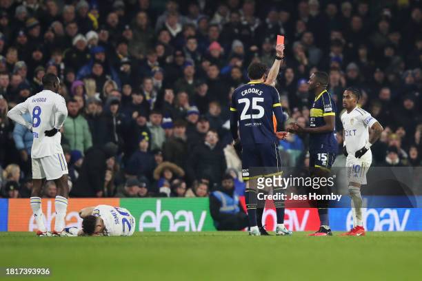 Referee Darren England shows a red card after a second yellow to Anfernee Dijksteel of Middlesbrough after a foul on Dan James of Leeds United during...