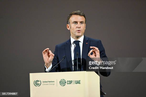 In this handout image supplied by COP28, French President Emmanuel Macron speaks during the Nature Season at Al Waha Theatre during day two of the...