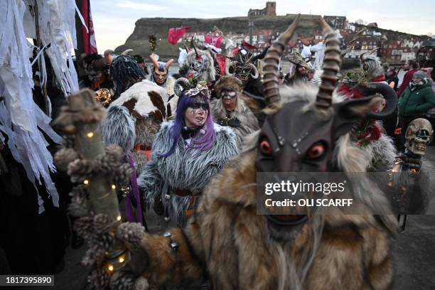 Participants dressed as "Krampus", a half-goat, half-demon figure that punishes people who misbehave during the Christmas season, prepare to take...