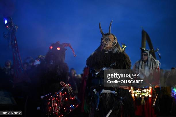 Participants dressed as "Krampus", a half-goat, half-demon figure that punishes people who misbehave during the Christmas season, take part in "The...