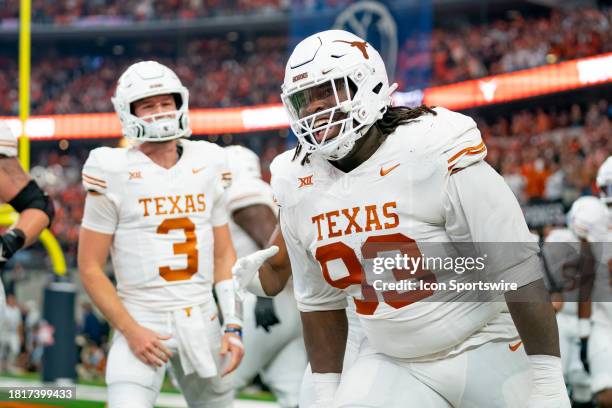 Texas Longhorns defensive lineman T'Vondre Sweat smiles after catching a touchdown pass during the Big 12 Championship game between the Texas...