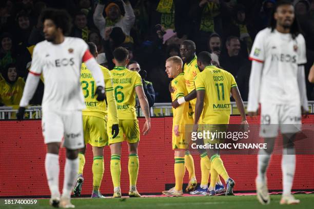 Nantes' French midfielder Florent Mollet celebrates with teammates after scoring a goal during the French L1 football match between FC Nantes and OGC...