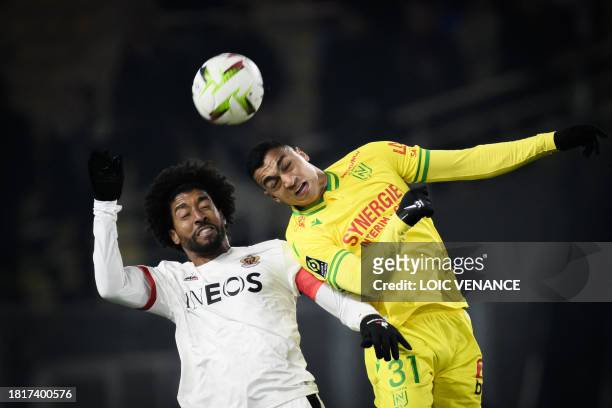 Nantes' Egyptian forward Mostafa Mohamed fights for the ball with Nice's Brazilian defender Dante during the French L1 football match between FC...