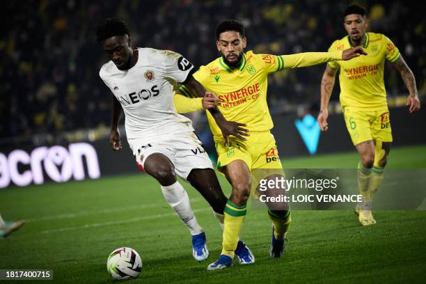 Nantes' Cameroonian defender Jean-Charles Castelletto fights for the ball with Nice's French forward Evann Guessand during the French L1 football...