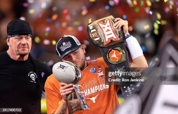 Wrestler The Undertaker looks on as quarterback Quinn Ewers of the Texas Longhorns celebrates after Texas defeated the Oklahoma State Cowboys in the...