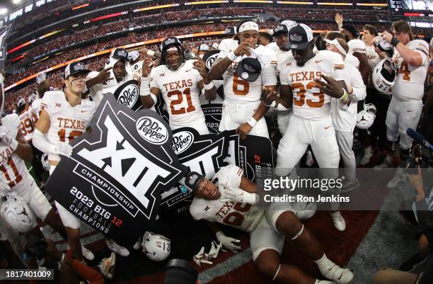The Texas Longhorns Celebrate after defeating the Oklahoma State Cowboys in the Big 12 Championship at AT&T Stadium on December 2, 2023 in Arlington,...