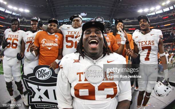 Defensive lineman T'Vondre Sweat of the Texas Longhorns celebrates with teammates after Texas defeated the Oklahoma State Cowboys in the Big 12...